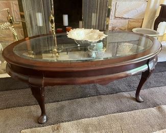 Oval wood coffee table with glass insert