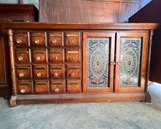 Authentic Walking Dead Show Prop:  This gorgeous dresser has two stained glass doors and 16 small drawers with glass knobs.  It can be seen in The Walking Dead Season 11 - Episode 14, in the panic room where Daryl and Rosita went to retrieve cash for Sebastian.  This item comes with a Certificate of Authenticity.  Check out the next picture to see where this dresser was located in the show.  Priced at $300.