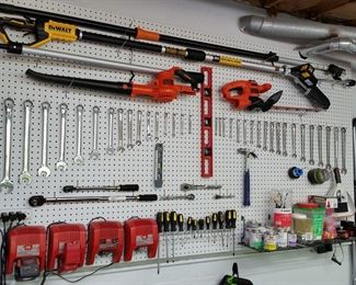 Assorted tools including a DeWalt cordless pruning saw and Black & Decker lawn tools