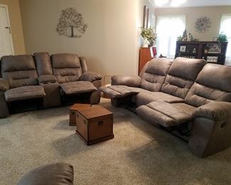 The leather sofa and loveseat with ends reclined