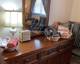 Dresser with mirror, porcelain lamp and women's purses