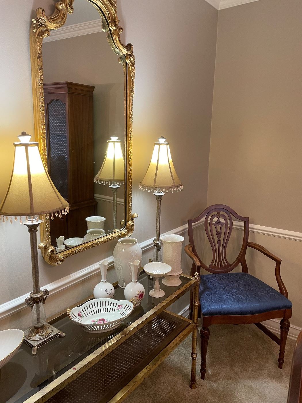 large gold framed provincial-styled mirror, long glass-topped console table, Lenox vases and covered dishes, pair of buffet lamps, and dining room armchair (5 side chairs and table also available)