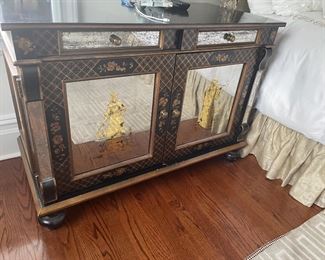 Black Chest with pair of drawers over double door cabinet, gilt decorative figural motif and mirrored accents 