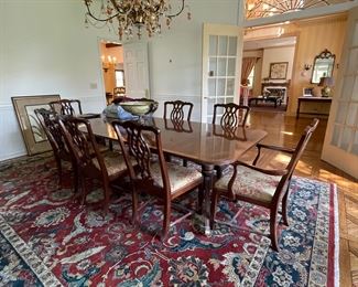 Chippendale style banded mahogany dining set; large hand woven Persian rug