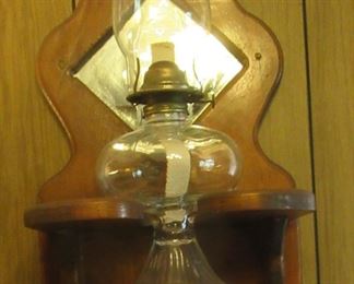 Pair of mounted oil lamps.