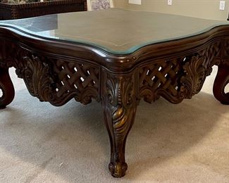 Large low ornate wooden coffee table w/leather top and custom cut glass