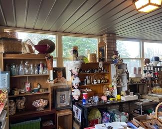 Vintage glass bottles, masquerade ceramic masks, several baskets and vases of sea shells, vases, bowls, glasses, baskets, a little bit of everything.