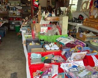 Garage full of tabled treasures including more Christmas items, crafts, households