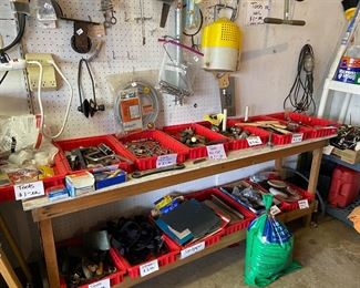 Several flats of tools on the table and also hanging on the wall