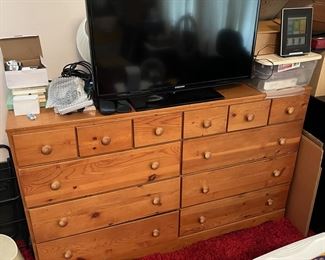 You don't see dressers of this size very often. Hurry and get it before someone else does. Oh, and there's a television here, too.