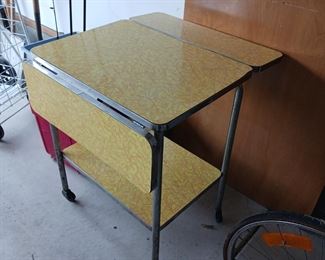 Yellow formica drop leaf beverage cart on wheels table