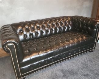 Black tufted sofa