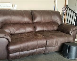 Close up of leather sofa, seats recline, distressed leather