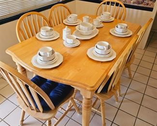 Wooden table with 6 chairs sold as set. Pfaltzgraff place setting for 6