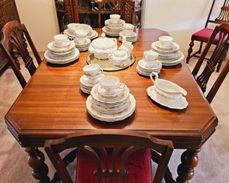 Wood dining table with 6 chairs and extra leaves. 