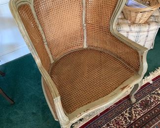 F42 - $95 Oversized wicker arm chair with caning. Measures 30" wide x 40.5" tall. 