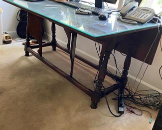 F15 - $125. Drop Leaf table with glass top for desk. Measures 18" (when folded) x 60" x 28" tall. Each leaf adds 12.5"
