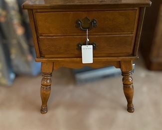 F25 - $50. Ethan Allen 2 drawer table. Solid wood very sturdy. Measures 20" wide x 25" deep x 23" tall. 