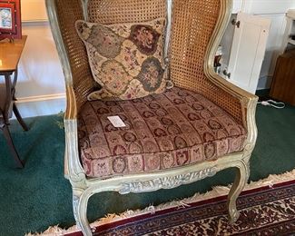 F42 - $95 Oversized wicker arm chair with caning. Measures 30" wide x 40.5" tall. 