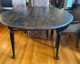 F45 - $75. Round Dining table painted black over wood. Measures 49.5" wide x 29" tall. 2 - 12" leaves included. 