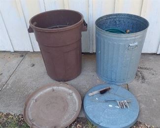 2 trach cans and garden hose