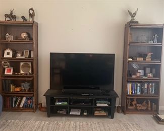 Flat screen TV with stand and solid wood book cases.