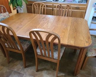 Oak dining table with leaf, table pads & 6 chairs (2 arm chairs & 4 side chairs); $225/set