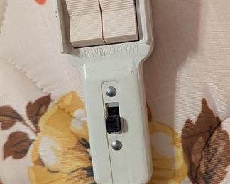 King-sized adjustable bed with attached remote controls