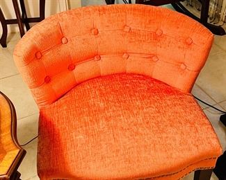 Two matching orange side chairs