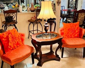 Two matching orange side chairs.