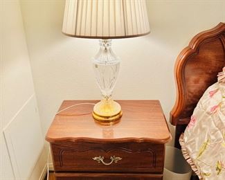 Two matching nightstands and a pair of matching crystal lamps.