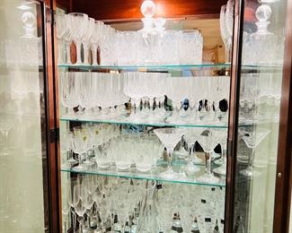 Beautiful curio cabinet full of crystal. 