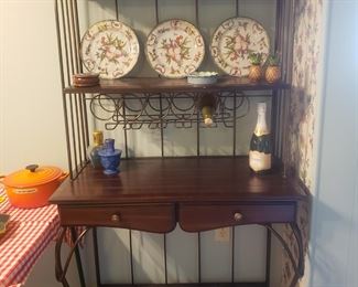 A very nice bakers rack with wine storage and two drawers