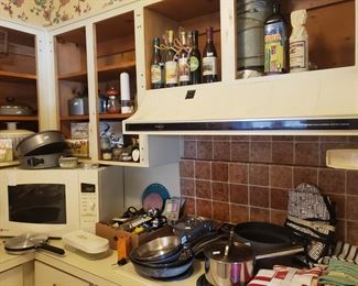 Lots of kitchen things- pans with names like All Clad, Anolon and more