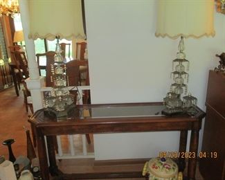 Console table with two ornate lamps with prisms