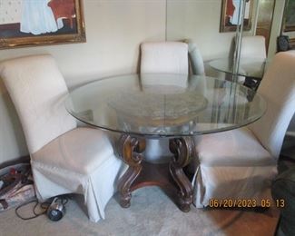 Glass table top and carved ornate base with 4 chairs (1 not pictured)