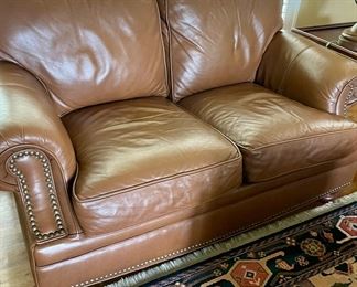 Leather love seat, carpets. 