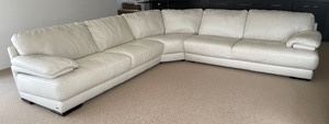 Gorgeous Cream Natuzzi Editions Sectional that measures 35 inches tall, 37 inches deep, the left side is 111 inches and the right side is 117 inches. There is some light wear.