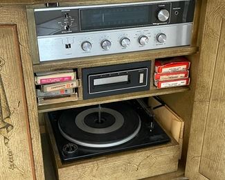 AM-FM radio, 8 track player and record player in the mid-1960s cabinet. Magnavox AM/FM radio and 8-track work great! Turntable does not work.