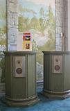 A pair of vintage Empire speakers, in a 20” cylindrical column format with antique green finish, complete with original paperwork.