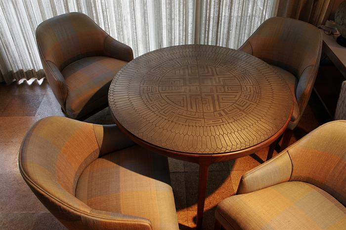 Unusual 39” round Italian walnut game table with etched bronze top, along with four corresponding upholstered chairs