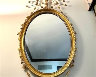 $300 - Gold gilt oval mirror with floral vase details - 23x48