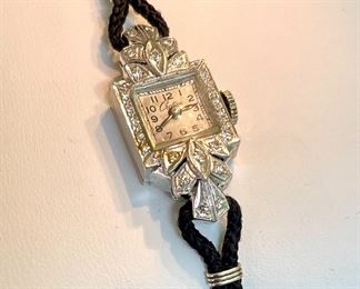 $500. Vintage Croton Ladies Watch. There are no visible markings on the watch indicating the metal or its purity. The diamonds test authentic. Band is TINY! 