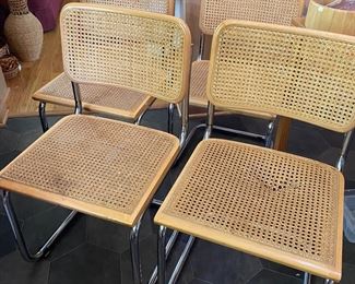 4 cantilever chrome, wood and cane chairs. Made in Italy. One has damaged cane seat, 3 have been reinforced on the bottom. 