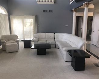 White leather sectional with black lacquered tables