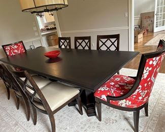 A.R.T classic dining room table and dark espresso . Eight chairs included.