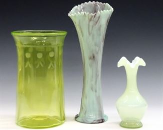 Three early to mid 20th century Art Glass vases.  Includes a cylindrical Vaseline Glass vase with flared rim and etched decoration, a cased Vaseline Glass vase with ruffled rim, and a flared Slag Glass vase with scalloped rim.  Taller Vaseline vase with some surface wear and flea bites, smaller with small amount of trapped water in foot.  6 1/4" to 11" high.