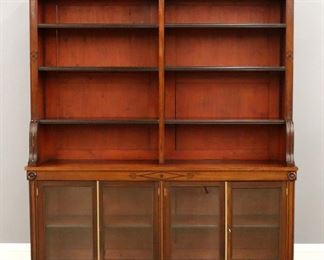 A 19th century English Regency transitional library case.  Mahogany construction with a flat top, inlaid frieze and adjustable open shelves flanked by shaped flat pilasters in upper section, the lower with four glazed doors, Brass astragals and a simple plinth base. Older polished finish with some wear and minor damage.  67 x 15 1/2 x 77" high overall. 