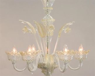 A 1970's vintage Murano Venetian glass chandelier.  Six arm design in colorless glass with Gold detail with twist arm design and alternating floral and foliate stems.  