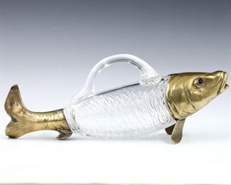 A turn of the century British novelty fish decanter in the style of Alexander Crichton.  Molded Crystal body flanked by cast Bronze head and tail with inset glass eyes.  Minor wear, lacks stopper.  13" long.
